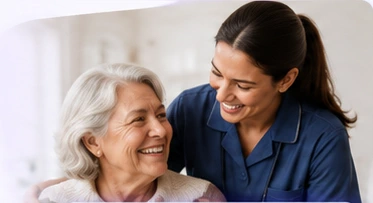 Caregiver smiling with an older woman at home